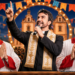 Arte ilustrativa sobre a mudança do show de Padre Fábio de Melo da Praça São Pedro para o Centro de Eventos, com crítica política à gestão João Fadel e ao secretário Fábio Nogueira.